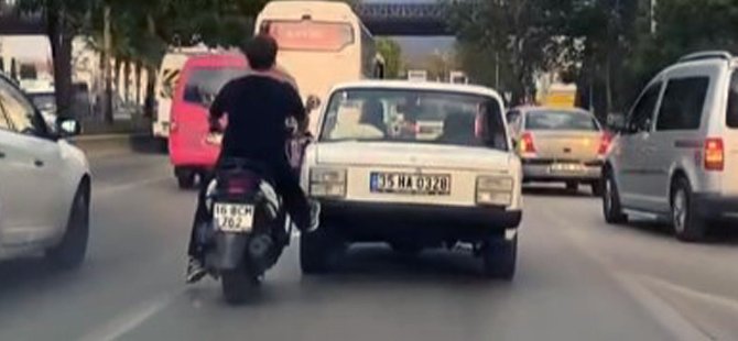 Bursa'da bir genç motosikletiyle otomobili itti
