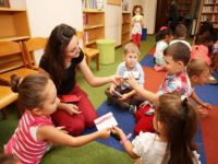 Çocuklar anneleriyle birlikte kütüphanede